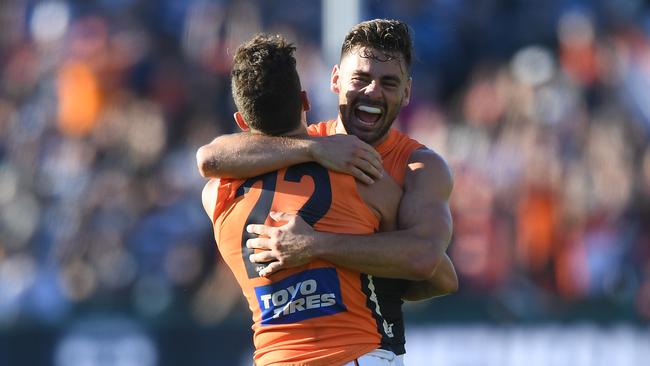 Stephen Coniglio and Josh Kelly embrace after the Giants beat the Cats in Round 4.