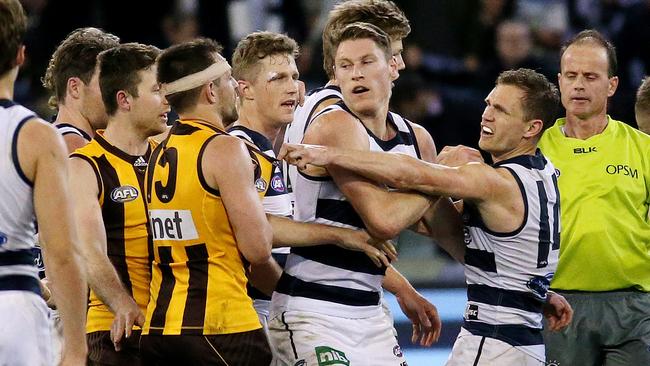 Captains Luke Hodge and Joel Selwood tangle at the three-quarter-time huddle. Picture: Colleen Petch