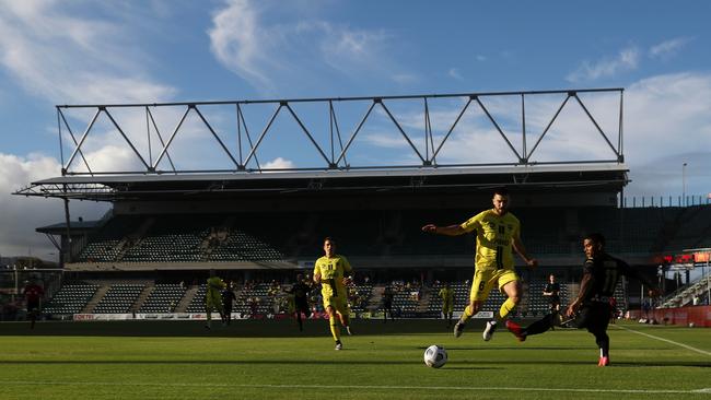 Kwame Yeboah of the Wanderers is tackled by Tim Payne of the Phoenix during the A-League match at WIN Stadium in Wollongong. Picture: Getty Images