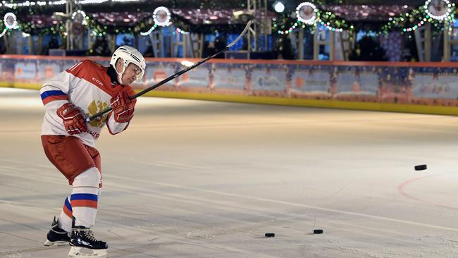 Vladimir Putin shoots a puck as he plays ice hockey at an outdoor ice skating rink in Mosow’s Red Square. last week Picture: Sputnik/AFP