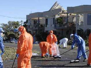 The clean-up of hazardous asbestos materials begins at Lennox Head after a tornado scattered debris throughout the streets. . Picture: Jay Cronan Northern Star