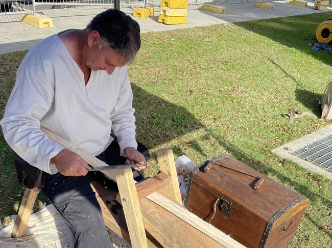 Boweyr Andrew Eggerling of the Riverbend Medieval Society crafts a longbow at the Fraser Coast Flavours Festival at Seafront Oval on September 1, 2023.