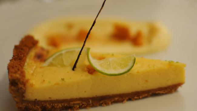 Coconut key lime tart with honeycomb and sweetened cream.