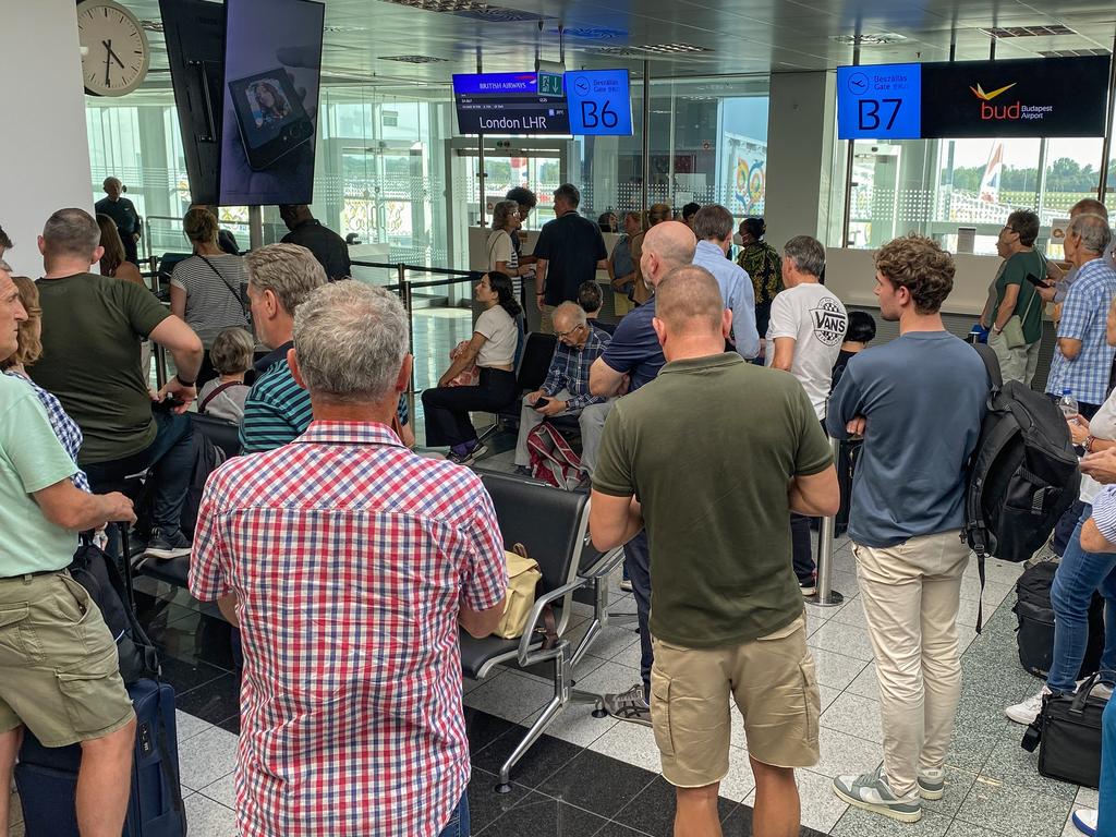 Passengers wait at a boarding gate for a British Airways flight bound for London at Budapest International Airport in Hungary after the UK’s air traffic control systems went down. Picture: Getty Images