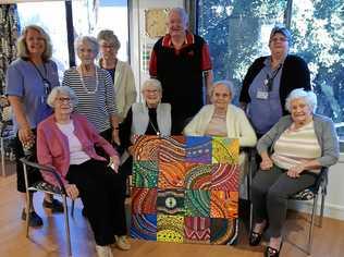 ENTHUSIASTIC PARTICIPANTS: Buderim Views aged-care residents learnt dot painting during Naidoc Week. They are pictured with their finished piece. Picture: Contributed