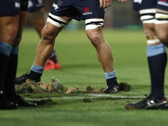 SYDNEY, AUSTRALIA - MARCH 09: Players replace divots after a scrum during the round four Super Rugby match between the NSW Waratahs and the Queensland Reds at the Sydney Cricket Ground on March 09, 2019 in Sydney, Australia. (Photo by Ryan Pierse/Getty Images)