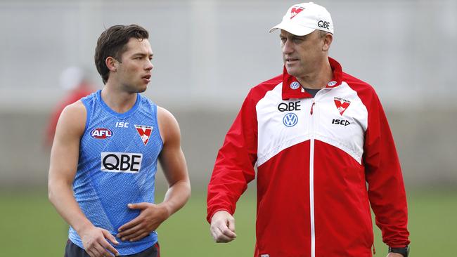 Oliver Florent, left, chats with coach John Longmire in 2019. Picture: Ryan Pierse/Getty