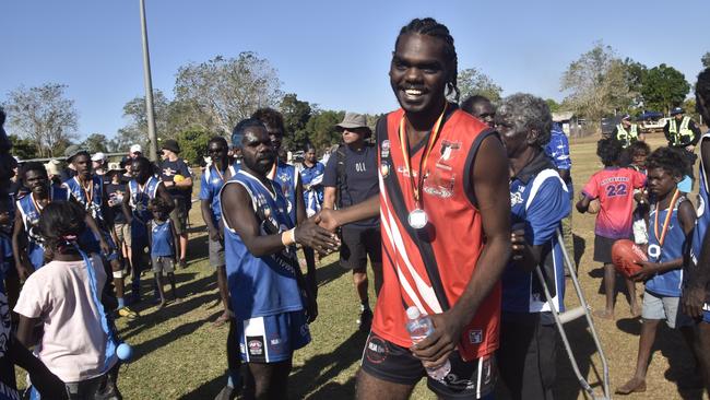 A Thunder player shaking hands with the Buffaloes following the win in the Tiwi Island Football League grand final between Tuyu Buffaloes and Pumarali Thunder. Picture: Max Hatzoglou