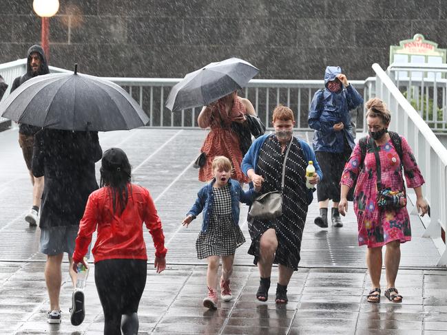 People run for cover at Southgate as the downpour drenches Melbourne. Picture: David Caird