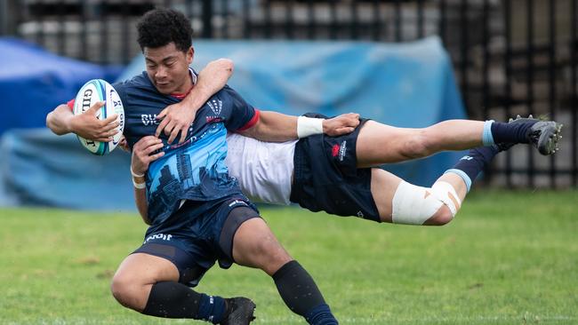 Rebels PJ Palu scores despite the attempted tackle by NSW Jack Matthews.