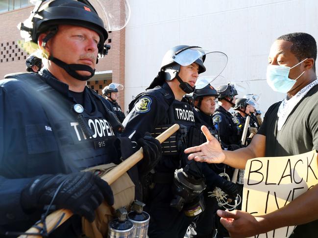 A demonstrator puts his hand out to police officers in Kansas City, Missouri.