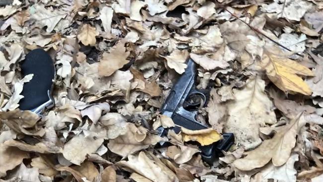 A young boy discovered weapons in leaves after police had searched the area.