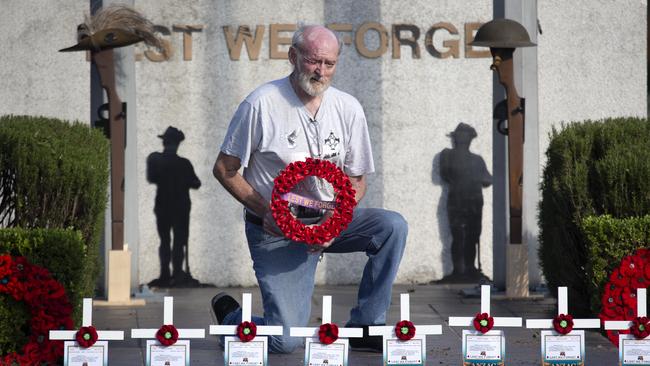 Mic Noble with his white crosses at the Logan Central memorial where there will not be a service this year. AAP/Image Sarah Marshall