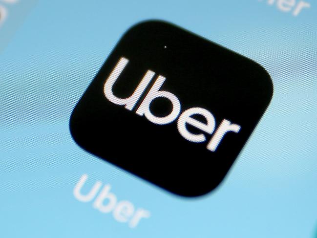 (FILES) In this file photo taken on April 11, 2019 the global ride-hailing giant, Uber application on a smart phone in Cologne. - Uber pulled back on its ambitious valuation target on April 26, 2019, while still pricing its share offering in a range that would make it one of the largest tech market debuts in recent years. The ride-hailing firm said in a securities filing it would sell 207 million shares in a range of $44 to $50 dollars, raising up to $10 billion. (Photo by Oliver Berg / dpa / AFP) / Germany OUT