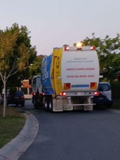 A council rubbish truck which residents earlier this year reported struggled to get down a narrow Oxenford street due to vehicles parked along it. Picture: Robbie Wright/Facebook.