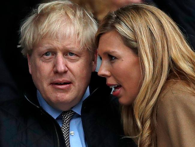 (FILES) In this file photo taken on March 07, 2020 Britain's Prime Minister Boris Johnson (L) with his partner Carrie Symonds attend the Six Nations international rugby union match between England and Wales at the Twickenham, west London - Britain's Prime Minister Boris Johnson and his partner Carrie Symonds have named their son Wilfred Lawrie Nicholas Johnson, in a tribute to their grandfathers and the doctors who helped save the Prime Minister's life. (Photo by ADRIAN DENNIS / AFP)