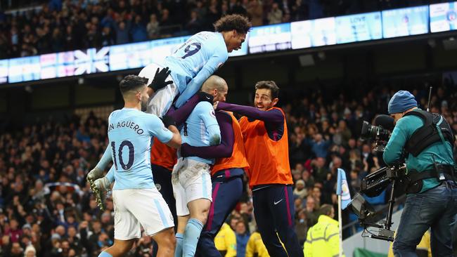 David Silva of Manchester City celebrates with teammates after scoring.