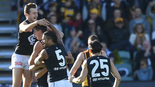 Carlton players mob Matthew Kreuzer after he kicked a goal in the club’s recent loss to Hawthorn. Picture: AAP Image/Julian Smith. 