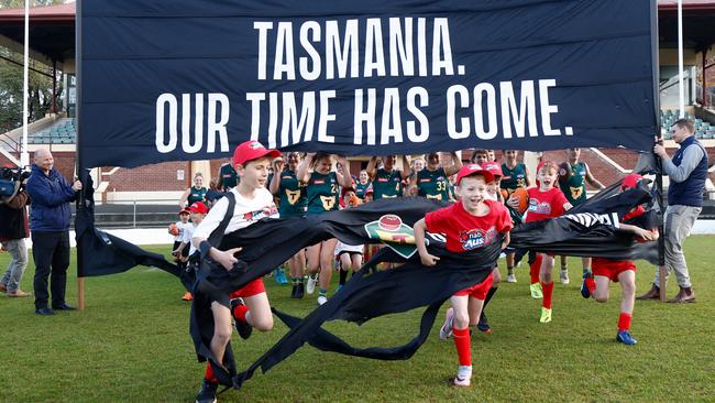 Junior players run though a banner during the AFL Tasmanian team announcement at North Hobart Oval on Wednesday. Picture: Getty Images