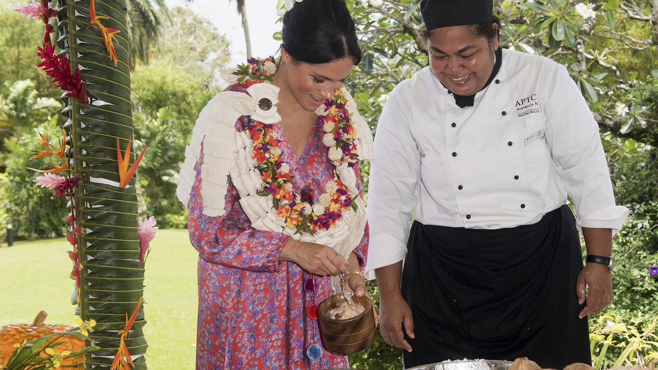 Meghan checks out the feast at a morning tea reception at the British High Commissioner’s residence in Suva. Picture: Samir Hussein.