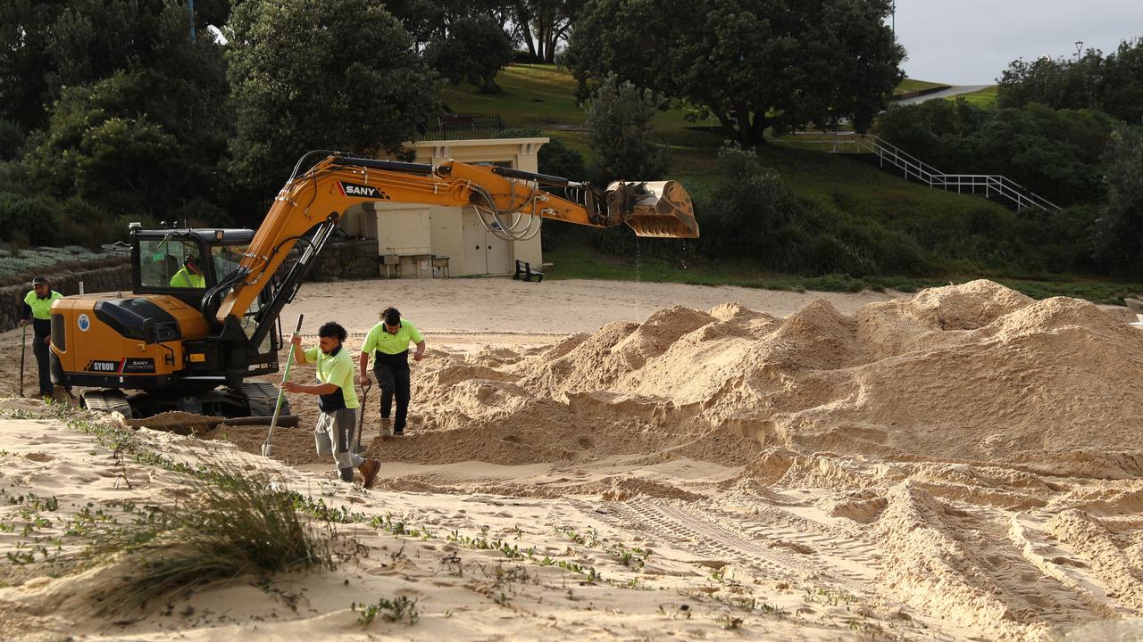 Council workers try to clean up North Coogee after the East coast low. Picture: John Grainger