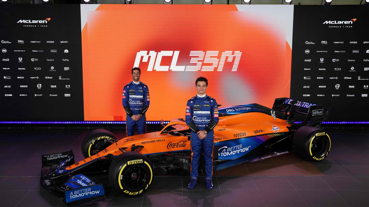 Daniel Ricciardo and Lando Norris with the new McLaren Formula 1 car MCL35M in Woking, southwest of London. (Photo by Handout / McLAREN / AFP)