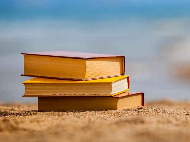 Closed books on a beach