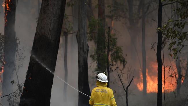 NSW Rural Fire Service crews burn a containment line to help contain the Gospers Mountain Fire. Picture: AAP Image/Dan Himbrechts.