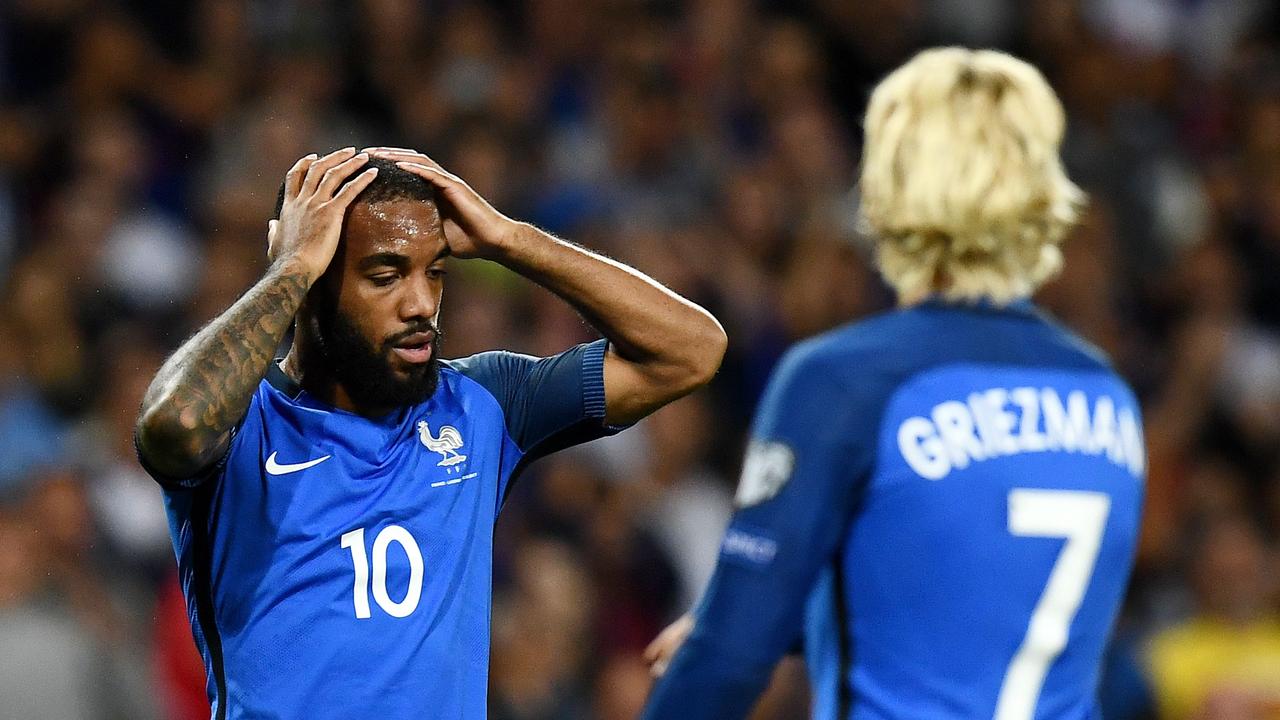 France's forward Alexandre Lacazette reacts after missing a shot on the goal