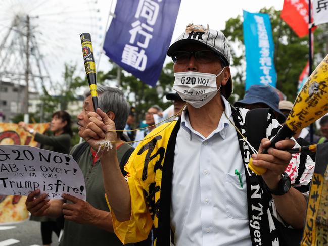 Protesters outside the event. Picture: Takashi Aoyama/Getty Images.