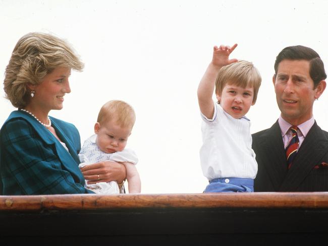 Diana the Princess of Wales holds Harry, and Prince William is held by Charles while in Venice in 1985.