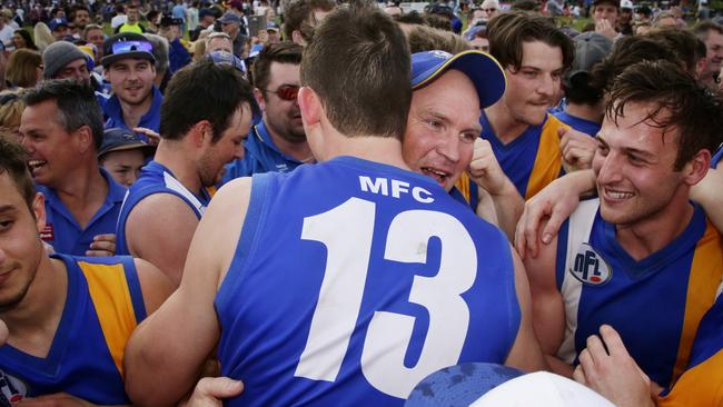 Coach Garry Ramsay embraces Jack Langford after Macleod’s most recent premiership in 2015. Picture: Hamish Blair