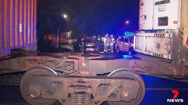 Police say the driver attempted a U-turn at the crossing on Jeffrey St around 9pm, but got stuck and had to abandon the car. Picture: 7NEWS