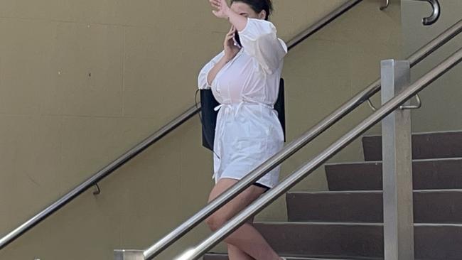 Mackay mum Madison Elizabeth Lamb tried to shield her face as she left Mackay court house after pleading guilty to extortion, fraud and drug supply charges. Picture: Janessa Ekert