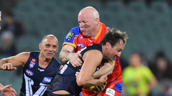 Andrew Jarman from the All Stars tackles Jude Bolton from Victoria during the AFL EJ Whitten Legends match between the All Stars and Victoria at Adelaide Oval in Adelaide, Friday, August 31, 2018. (AAP Image/David Mariuz) NO ARCHIVING, EDITORIAL USE ONLY