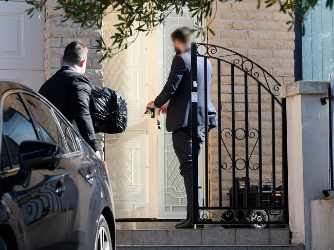 Australian Federal Police and ASIO officers at the MP’s house today. Picture: AAP