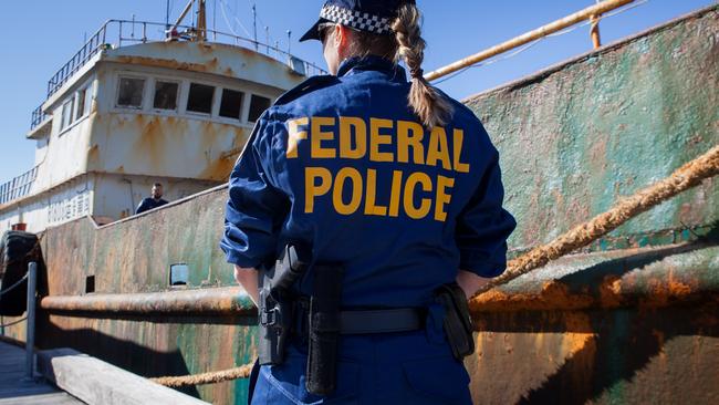 An AFP member prepares to board a ship during a drug operation.