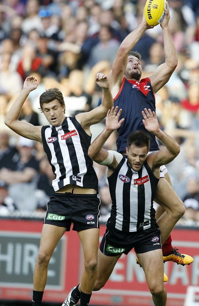 Melbourne forward Jesse Hogan flies for a mark over Collingwood defender Nathan Brown. Picture: Michael Klein