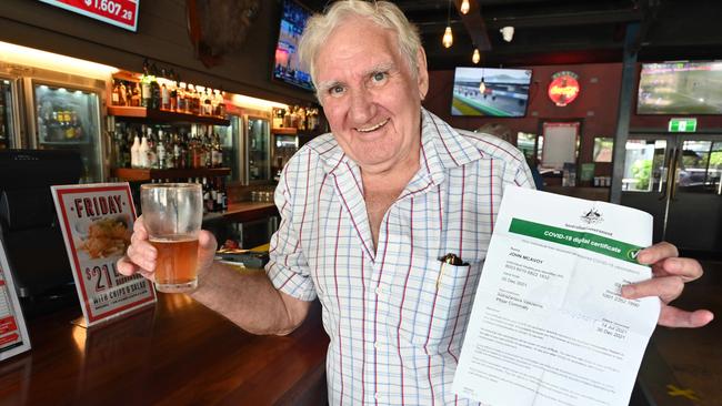 John McAvoy having a beer at Hotel Darwin. He carries around his vaccination certificate. Julianne Osborne