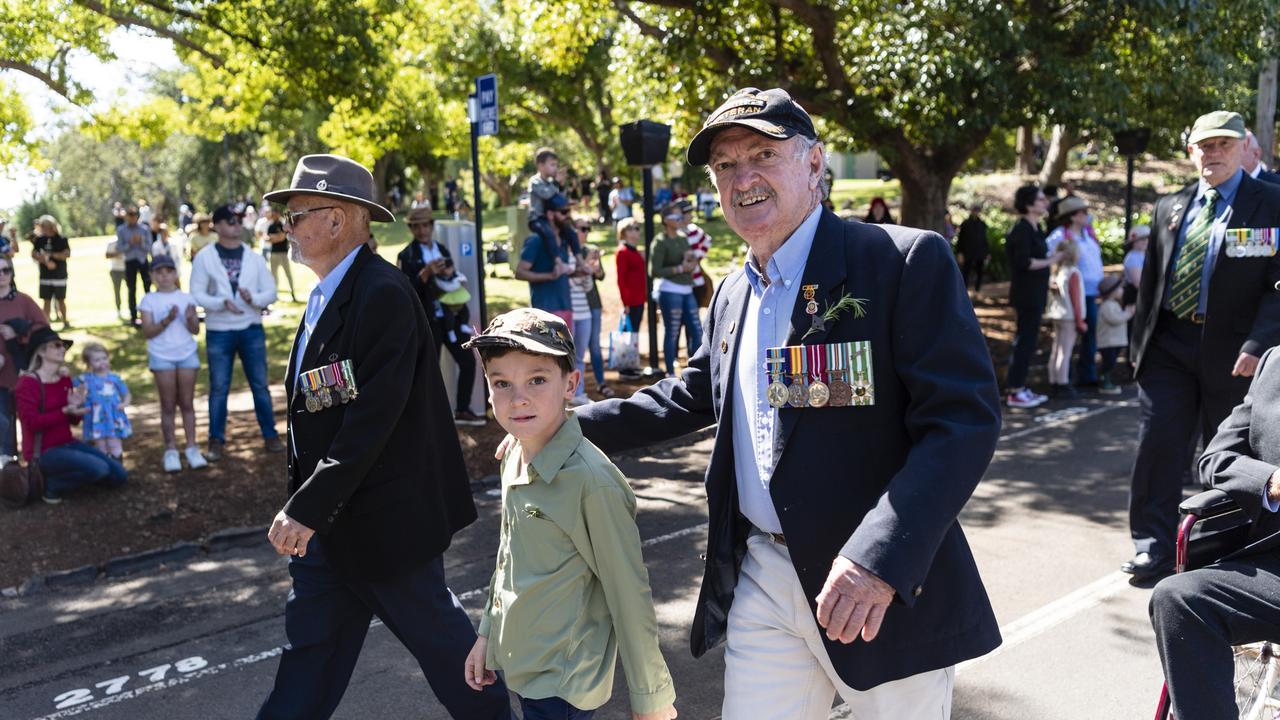 Traves Moloney marches with his granddad Mike Moloney with the Vietnam veterans after the Anzac Day Toowoomba mid-morning Service of Remembrance at the Mothers' Memorial, Tuesday, April 25, 2023. Picture: Kevin Farmer