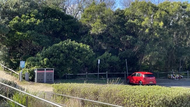 The car park at Park Beach, Coffs Harbour. Floral tributes can be seen to the right of the photo. Picture: Janine Watson/Coffs Coast Advocate