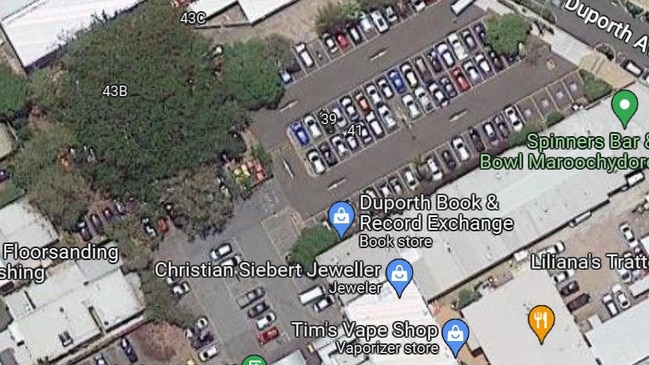 An aerial view of the fig tree, top left, that the Sunshine Coast Council has decided to remove to make way for more car parks. Picture: Google Maps