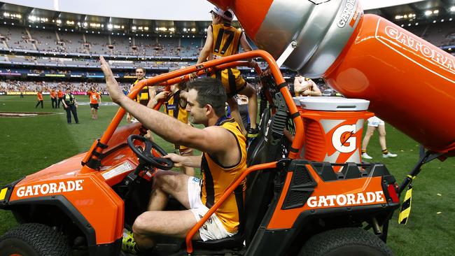 After claiming a third premiership medal, Brian Lake took one of the sponsor’s vehicles for a spin on the MCG. Picture: Wayne Ludbey