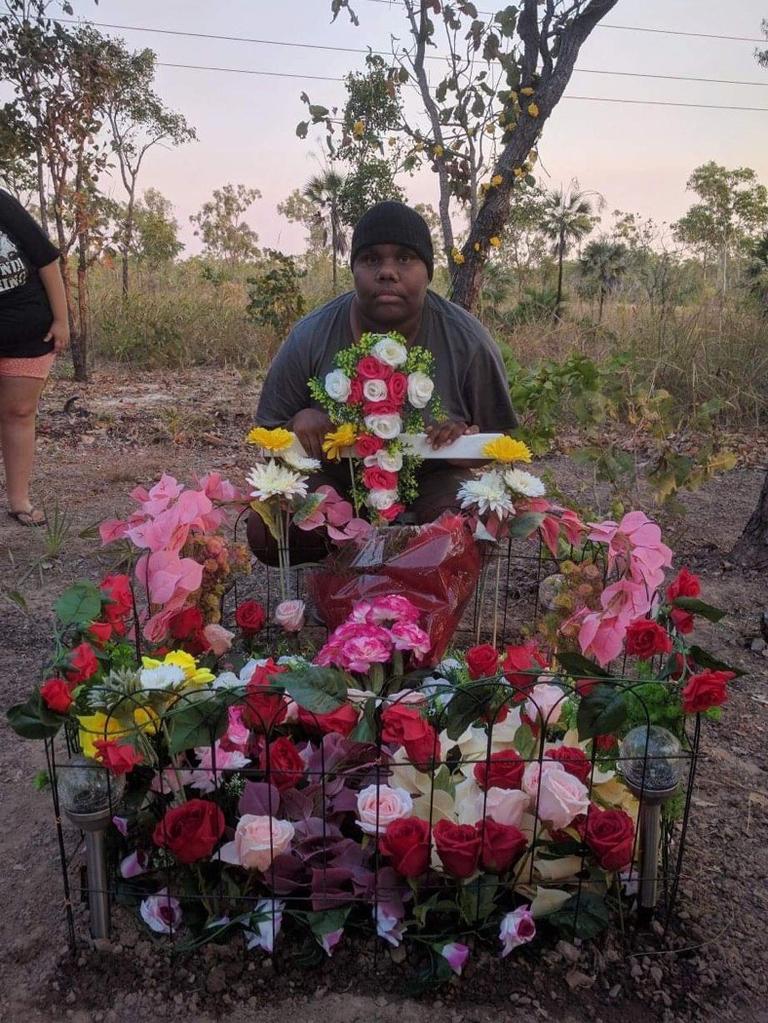 Janita Dixon, the daughter of alleged hit and run victim Kumanjayi Napurrurla Dixon, at her mother's roadside memorial.