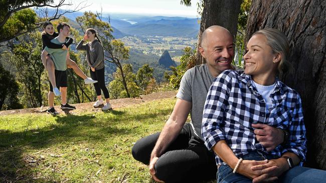 Kate Lawrence and partner Justin Johnson with their son Eden Johnson, 17, and daughters Kirra, 15, and Emily Johnson, 13, visiting the site of the burnt down Binna Burra Lodge, at Binna Burra in the mountains behind the Gold Coast. There is to be a new replacement lodge development after the original building destroyed in 2019 bushfires. Picture: Lyndon Mechielsen/The Australian