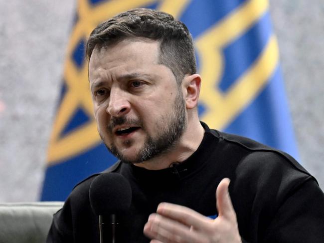 Ukrainian President Volodymyr Zelensky gestures as he gives a press conference in Kyiv on February 24, 2023, on the first anniversary of the Russian invasion of Ukraine. (Photo by Genya SAVILOV / AFP)