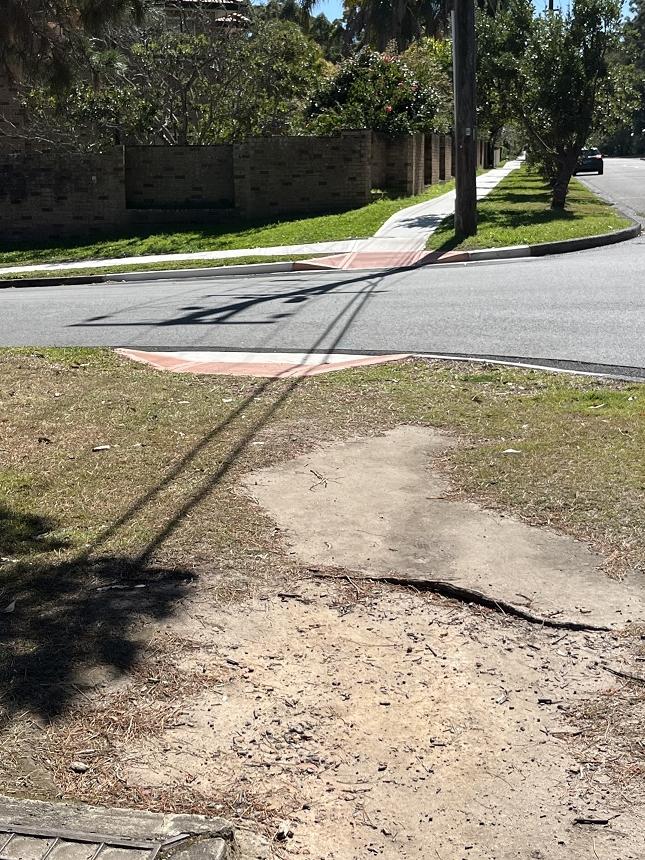 A photo of a street adjoining Bradfield Rd which is afforded a footpath.