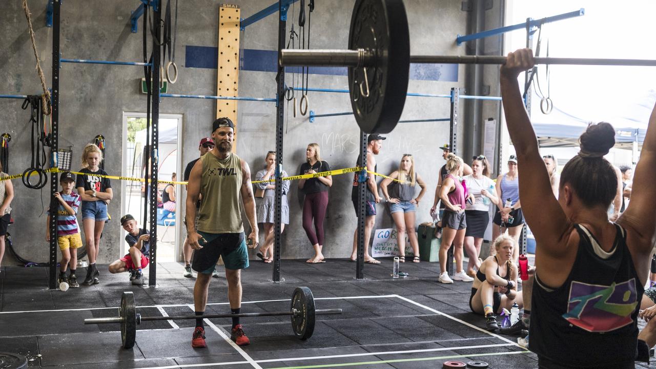 Mitch Lippiatt (left) waits for teammate Bree Gibbons to complete her lift during the Brett Forte Memorial Challenge hosted by CrossFit Toowoomba. Picture: Kevin Farmer