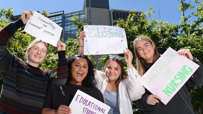 (L-R) Shelby Dedman, Makayla Hudson, Caitlyn Legg and Lucinda Stephens have had early offers from Australian Catholic University holding up signs saying what they got in to. Picture: Josie Hayden