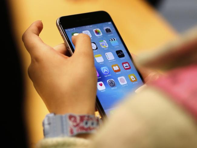 FILE - A child holds an iPhone at an Apple store on Sept. 25, 2015 in Chicago. (AP Photo/Kiichiro Sato, File)